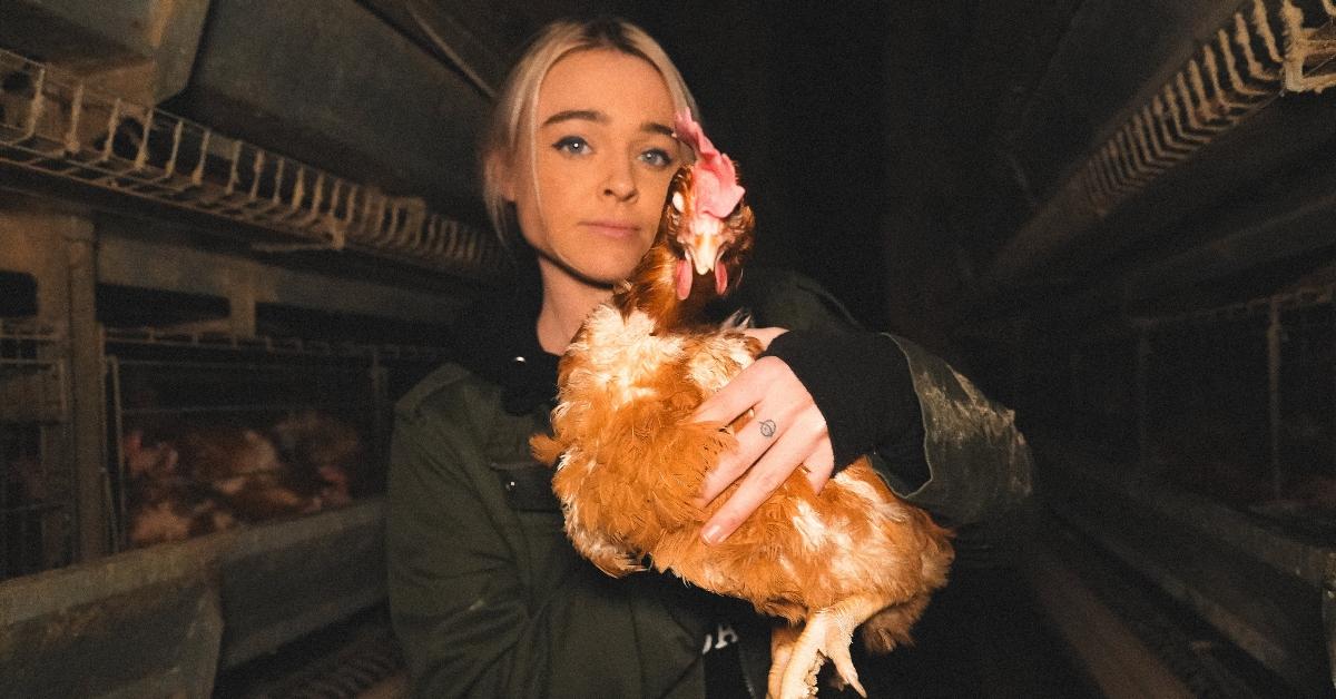 Tash Peterson hugs a chicken. 