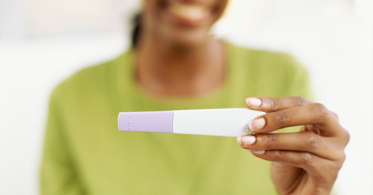 Woman holding a pregnancy test
