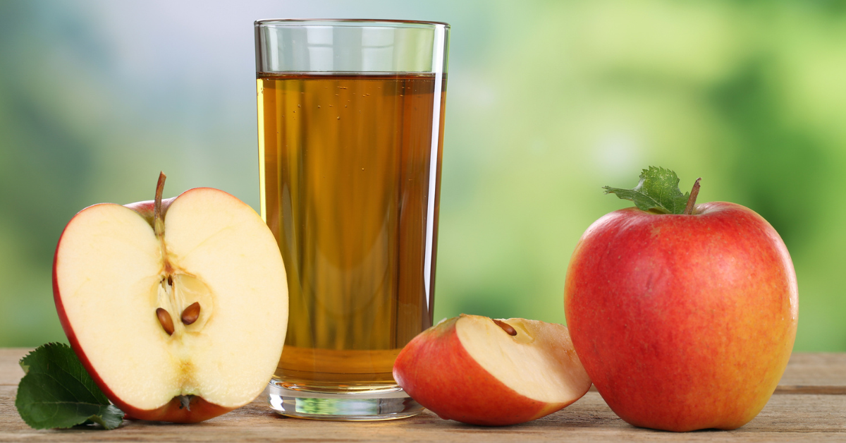 Apples and a glass of apple juice on a table