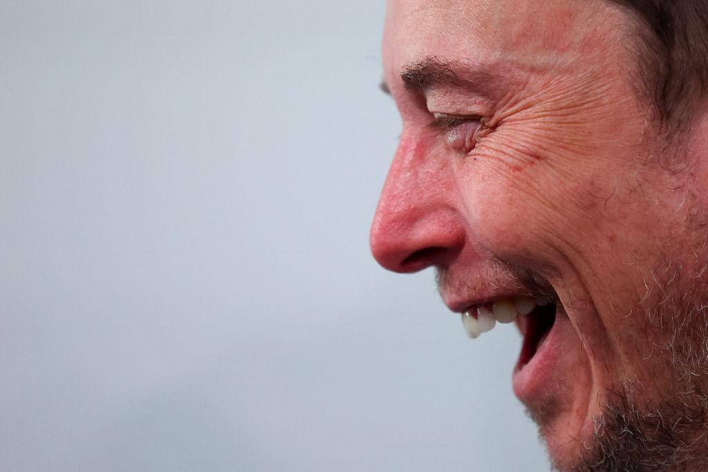 A close-up shot of Elon Musk smiling at the AI Safety Summit in November 2023 in England.